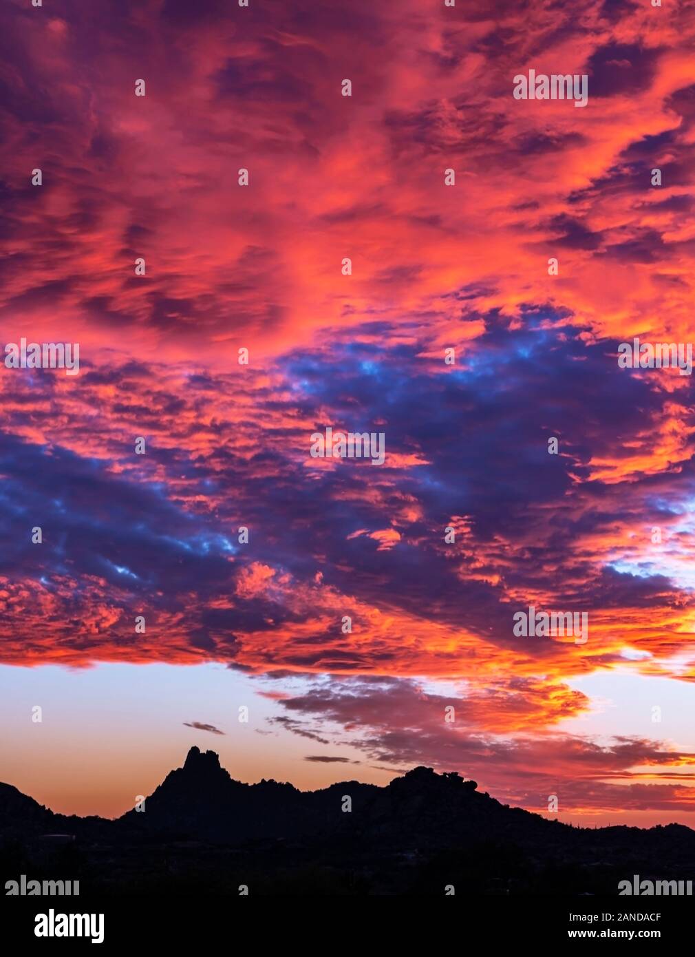 Vibrant and fiery sunset near Pinnacle Peak landmark in North Scottsdale, AZ.. Stock Photo