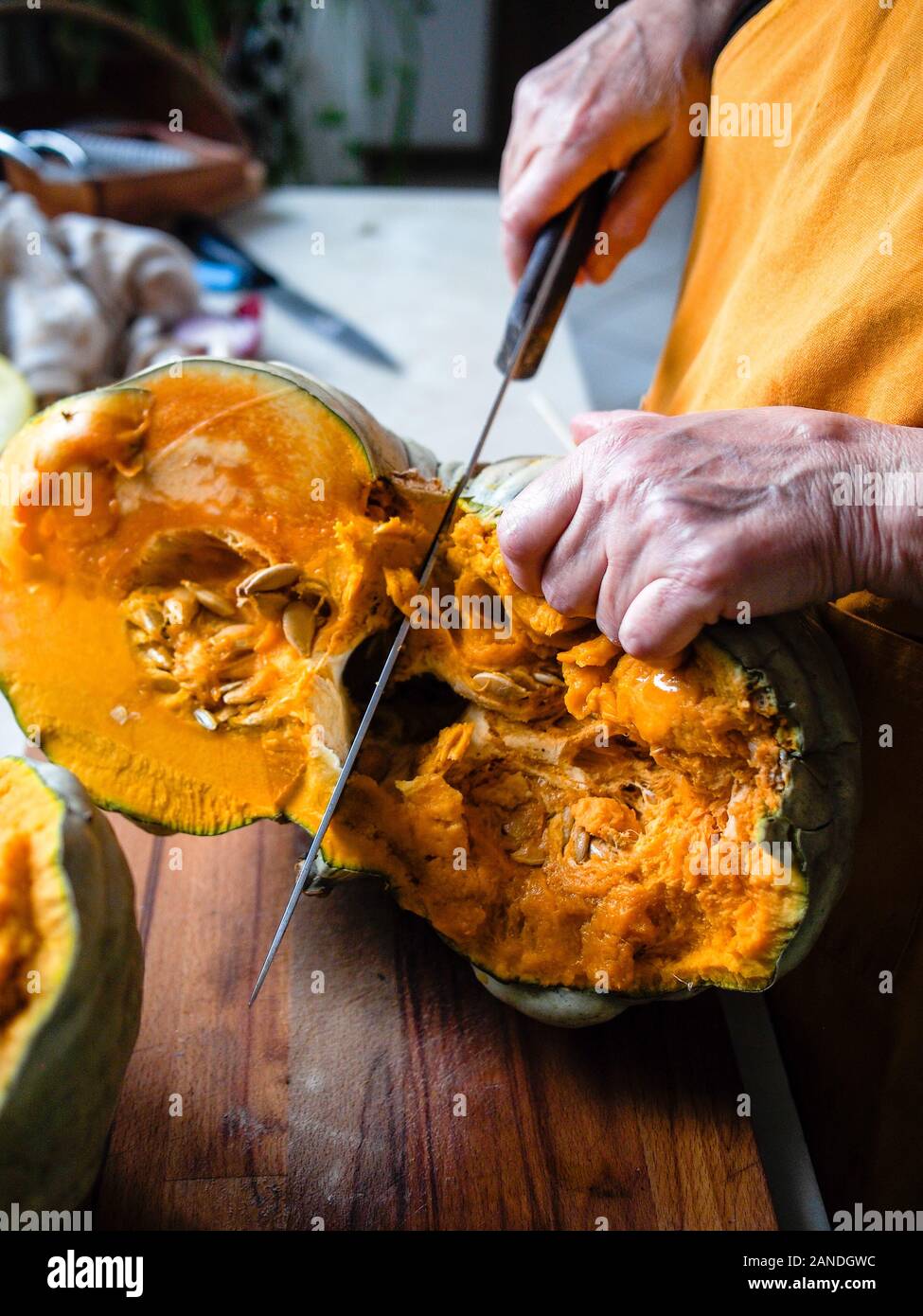 Preparing and cutting a fresh bio pumpkin Stock Photo