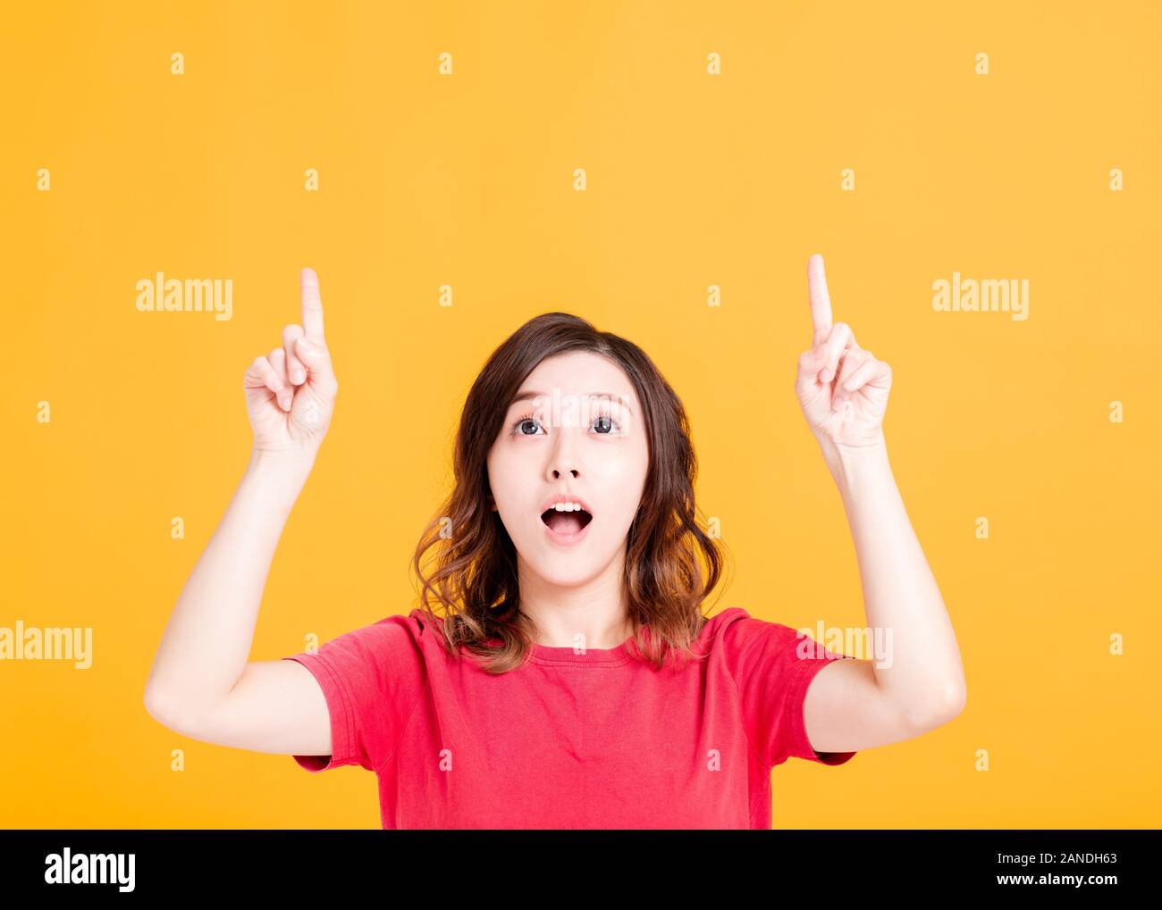 Young pretty woman  looking and pointing up Stock Photo