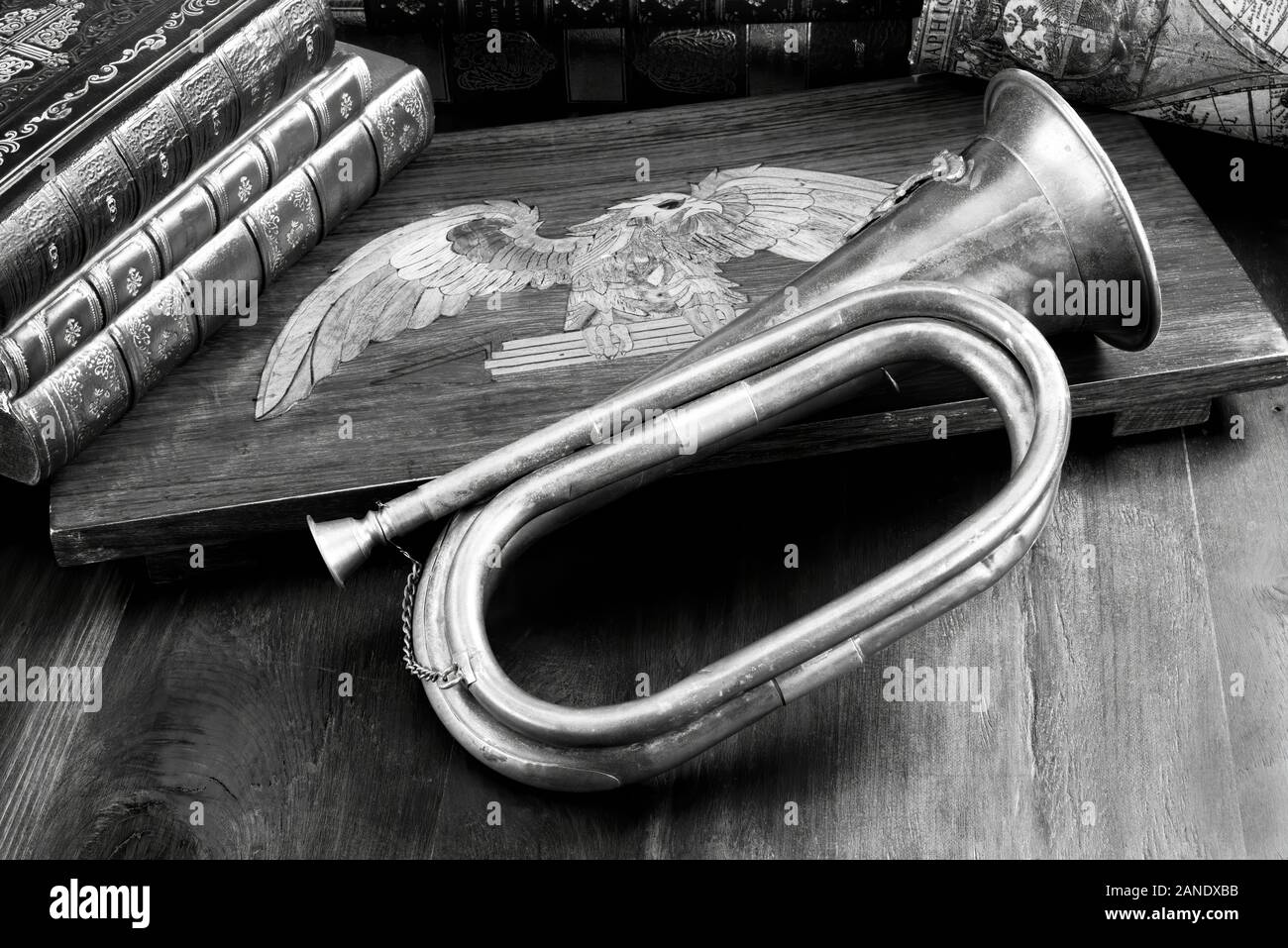 Antique brass bugle, wooden eagle in black and white. Stock Photo