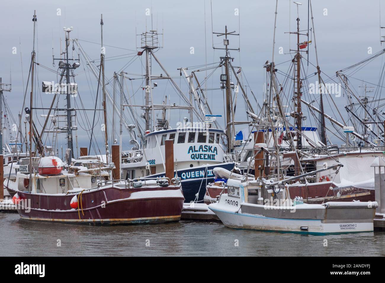 Commercial fishing boats under a blanket of snow in Steveston Harbour