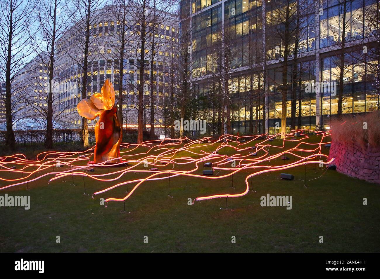 Squiggle art installation is seen during the opening day of the Canary Wharf Winter Light Festival in Docklands, London. The festival is open to public daily from 4pm to 10pm until 25 January 2020. Squiggle is a winding mass of 450 metres of digital neon tubing twisting and turning to fill Jubilee Park. This unique sensory journey is created by the artist's innovative manipulation of space and sense. Interact with the installation, an abstract reflection of this very multicultural world we live in by viewing it from all its different angles as you venture through the park. Stock Photo