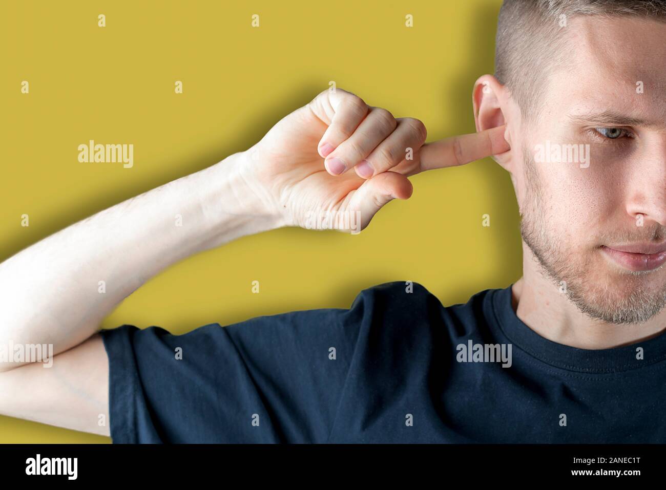 stop that noise! the male feels bad and closes his ear with his hand