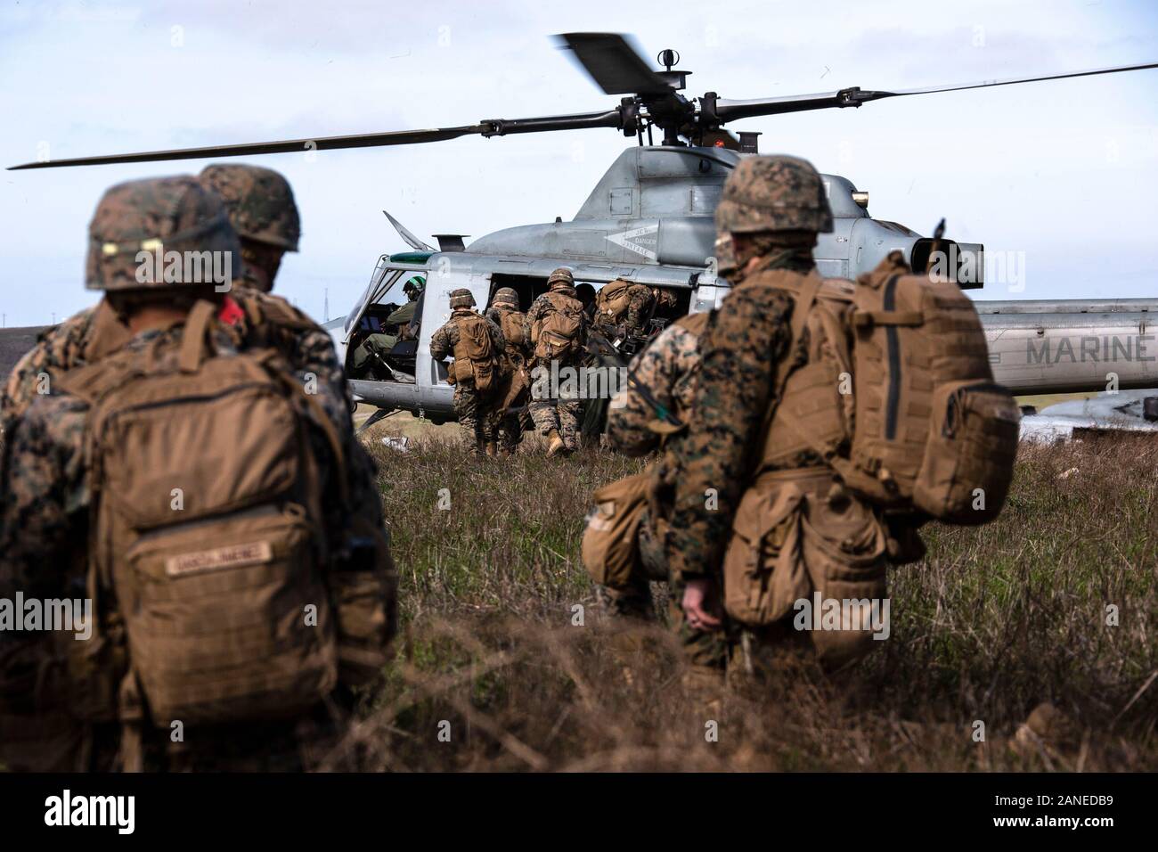 U.S. Marines with 2nd Battalion, 4th Marine Regiment, 1st Marine Division embark on to a UH-1Y Venom with Marine Light Attack Helicopter Squadron 469, Marine Aircraft Group 39, 3rd Marine Aircraft Wing, for extraction from a landing zone during Exercise Venom Storm on San Clemente Island, Calif., Jan. 15, 2020. Exercise Venom Storm demonstrated the Venom’s versatility in providing lethal options, whether operating from the sea or land. It’s ability to rapidly deploy from ship-to-shore, support ground forces with its own organic fire support and be armed and refueled at temporary sites is unmat Stock Photo