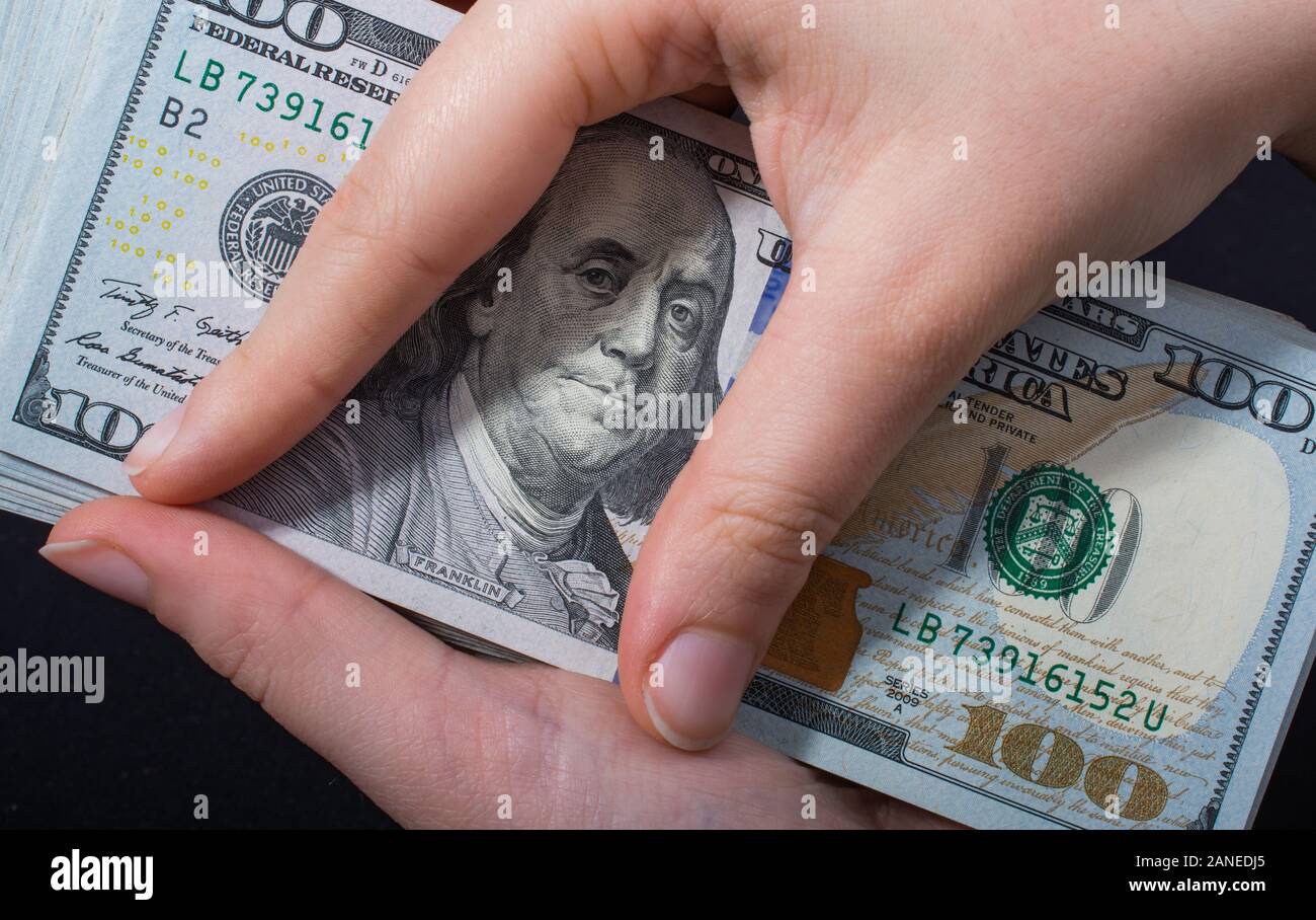 Hand holding American dollar banknotes isolated on white background ...