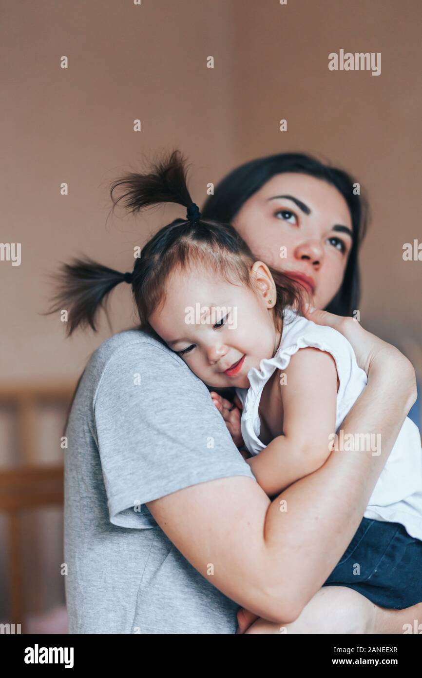 Young mother holding her little child girl. Stock Photo