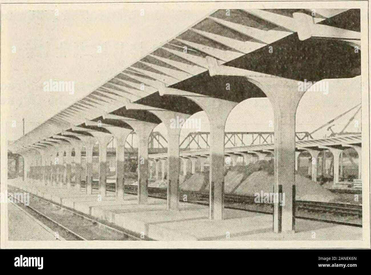 Engineering and Contracting . building at a time, thus per-mitting the concrete floor on that half to be poured whilethe walls on the other end are being carried up. By thismethod the stone masons, brick masons and carpenterscan be kept busy practically all of the time and the con-crete floors are given sufficient time to set before resum-ing the construction of the outside walls. Norman T. Vorse, 911 S. & L. Bldg., Des Moines, la., isthe architect. The Boyd Construction Co.. 312 GermaniaLife Bldg., St. Paul, Minn., is the general contractor. 358 DESIGN AND CONSTRUCTION OF THE UNIT-BUILT REINF Stock Photo