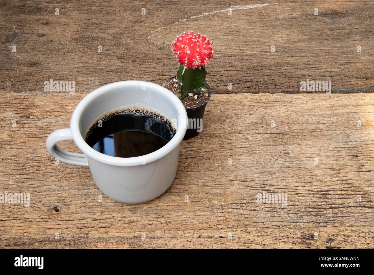 A tin cup of coffee on the wooden table background. Stock Photo