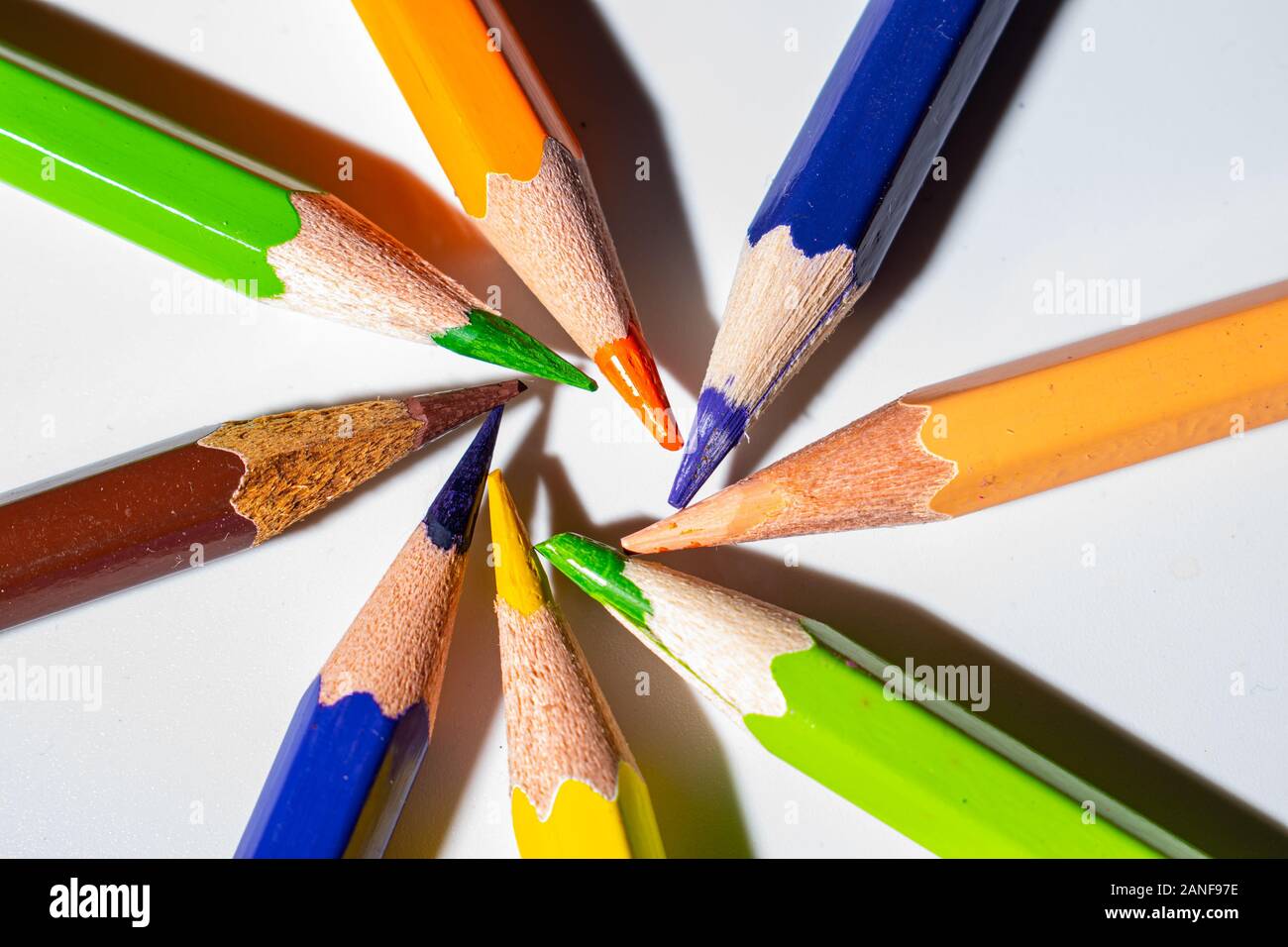 Different colors of pencils, in a spiral pattern. Colored crayons arranged in a meaningful way. Stock Photo