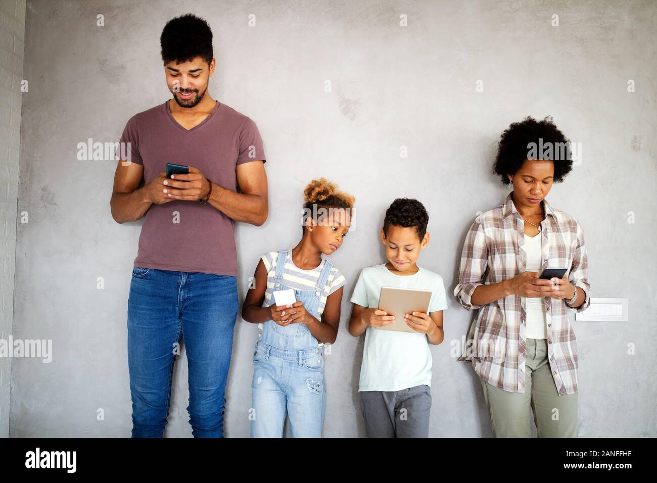 Family sharing there privacy data by using digital devices, phones, tablets Stock Photo