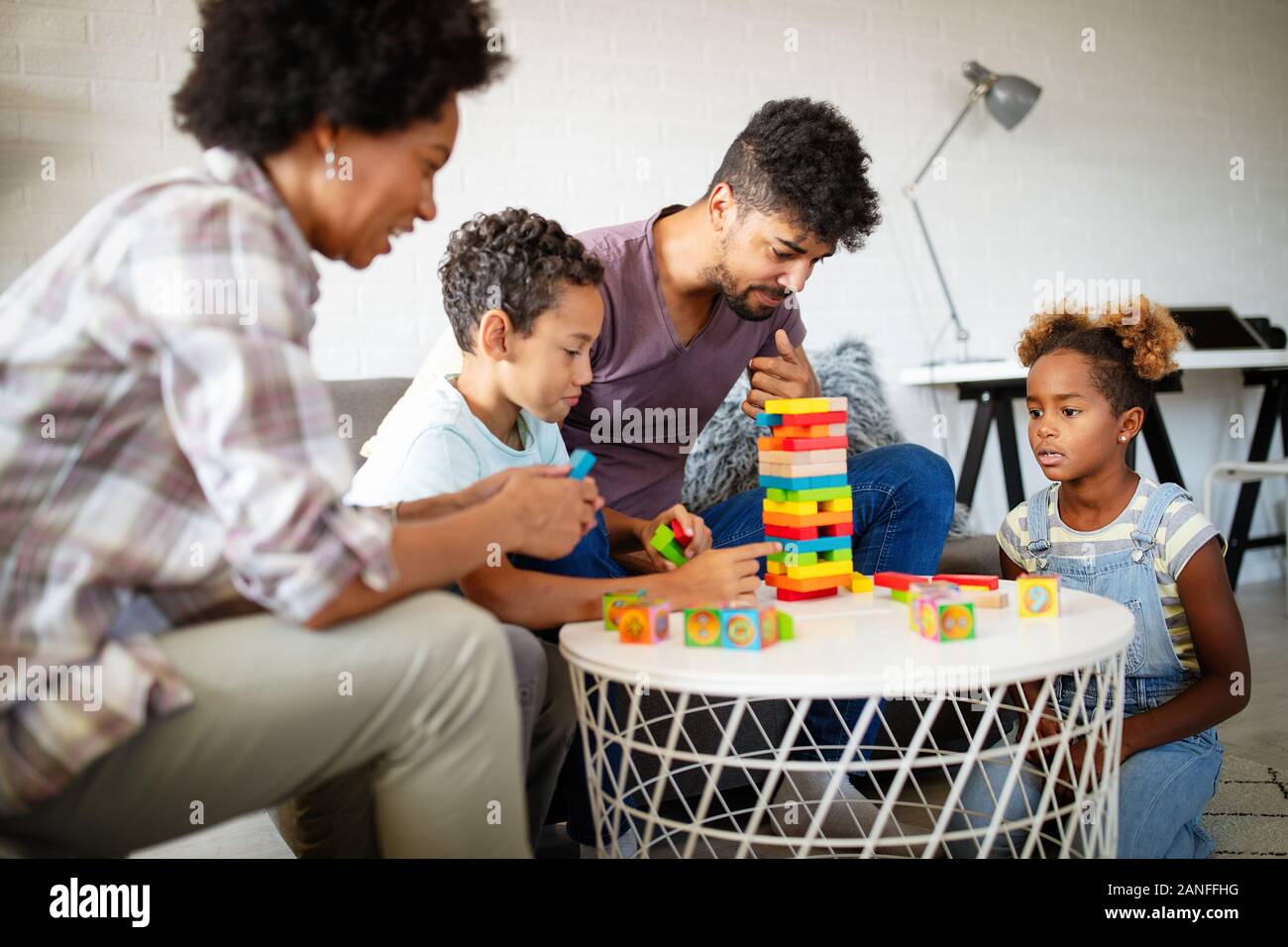 Family time. Young black parents with two kids playing together at home Stock Photo