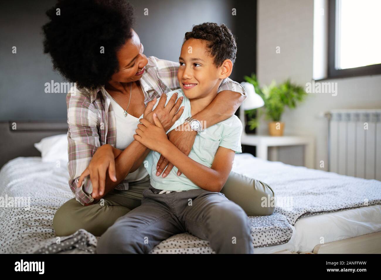 Mother playing bonding hugging with her son. Happy family time. Stock Photo