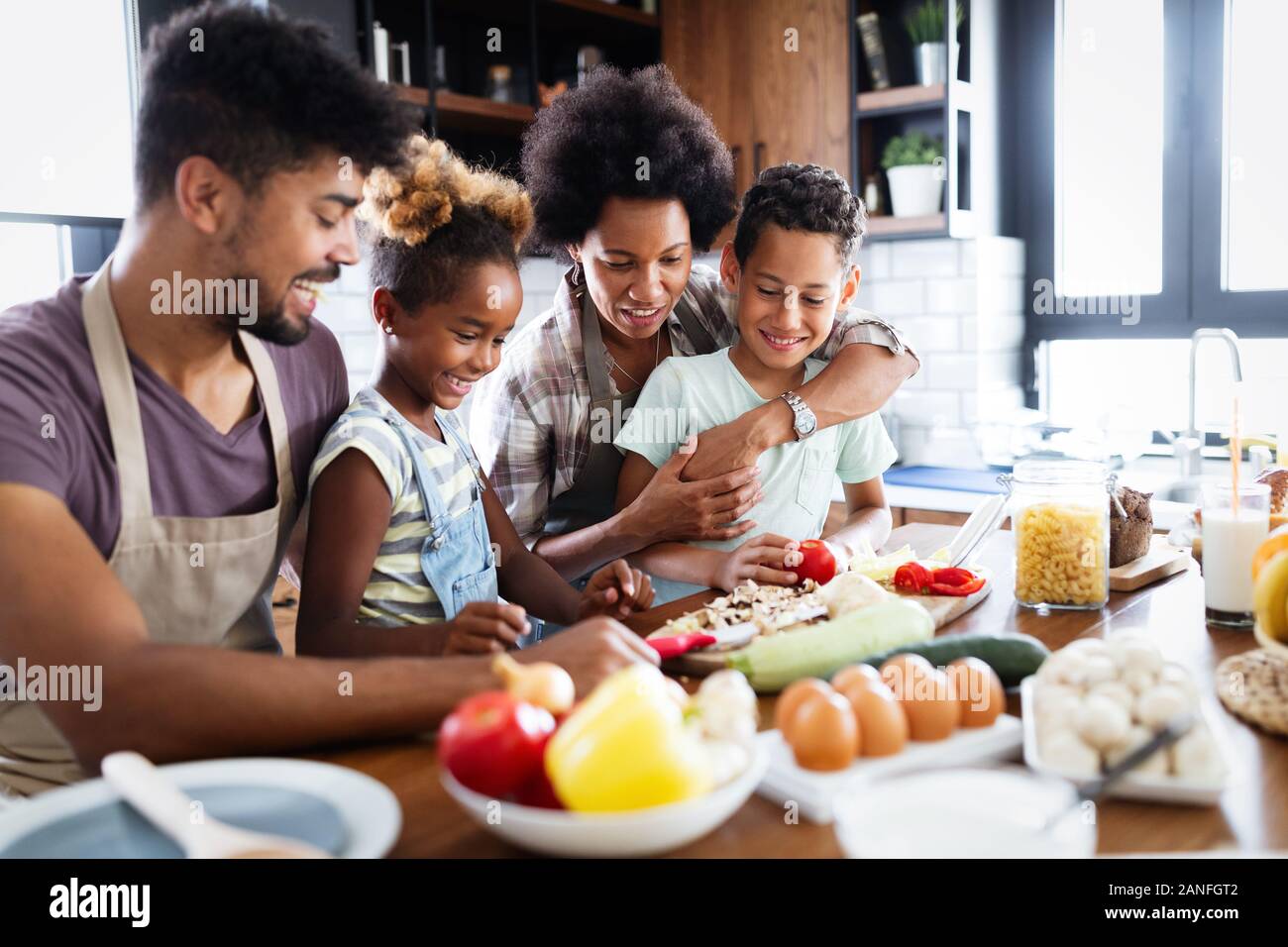 Happy family preparing together food in the kitchen Stock Photo