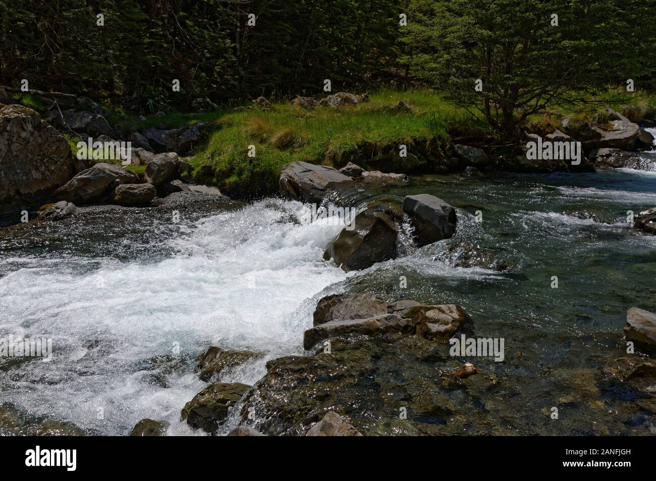 White water is formed by a river flowing over boulders. Stock Photo