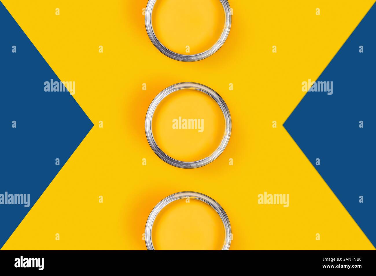 Repair picture. Classic blue and yellow background with three yellow paint cans. Flat lay, top view, copy space. Stock Photo