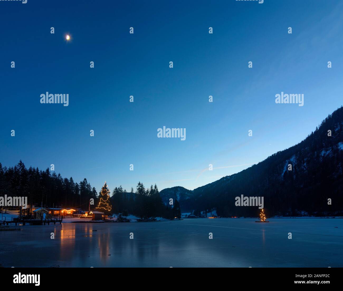 St. Ulrich am Pillersee: lake Pillersee, Christmas tree, restaurant Seestüberl, moon in Kitzbüheler Alpen - Pillersee Tal, Tirol, Tyrol, Austria Stock Photo