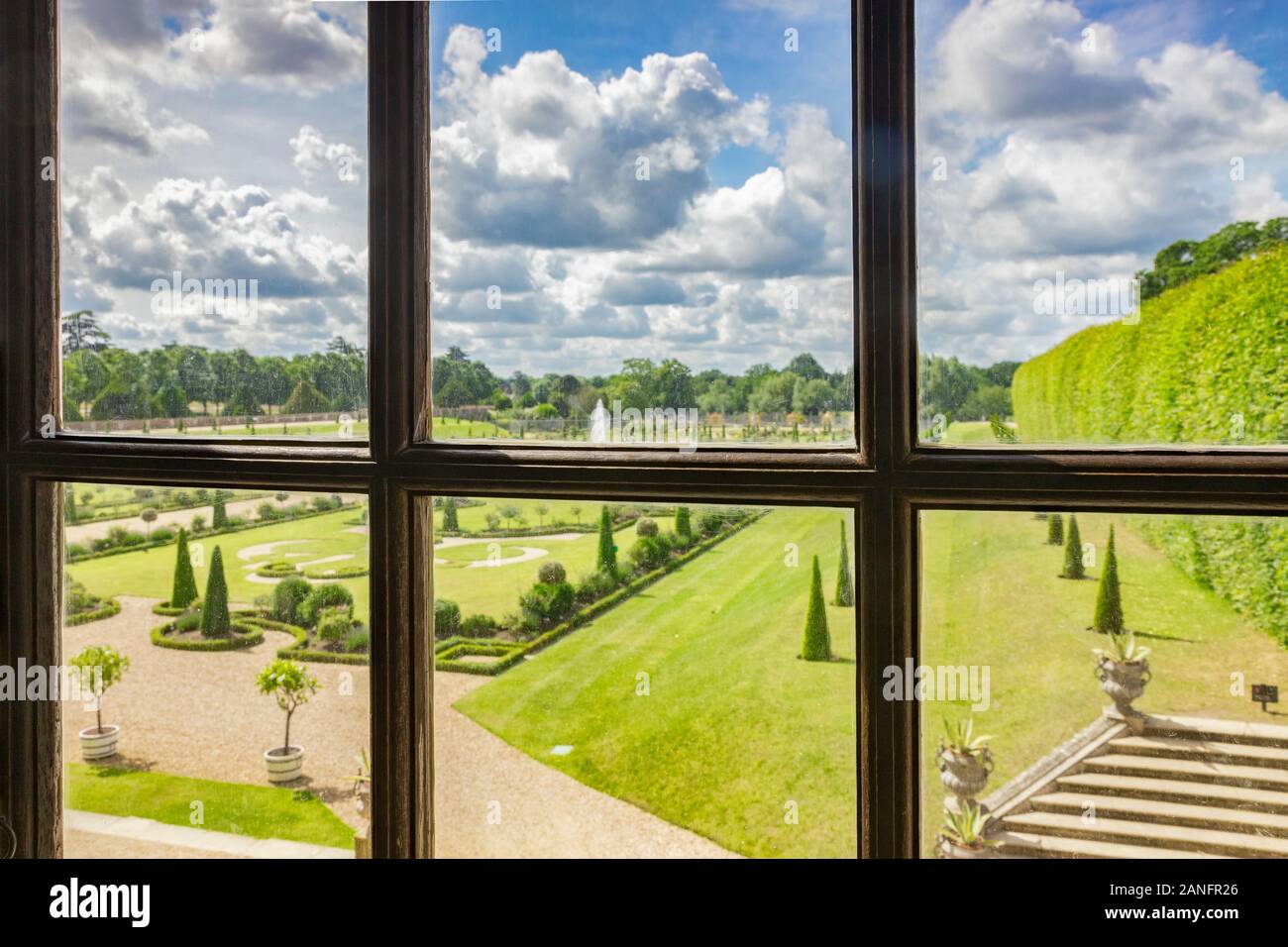 9 June 2019: Richmond, UK - A view through a window of Hampton Court Palace, of the Privy Garden. Focus on window frame, best used small. Stock Photo