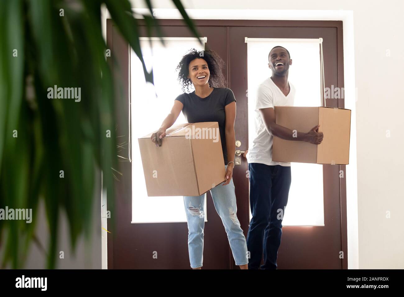 Excited black couple impressed entering new home together Stock Photo