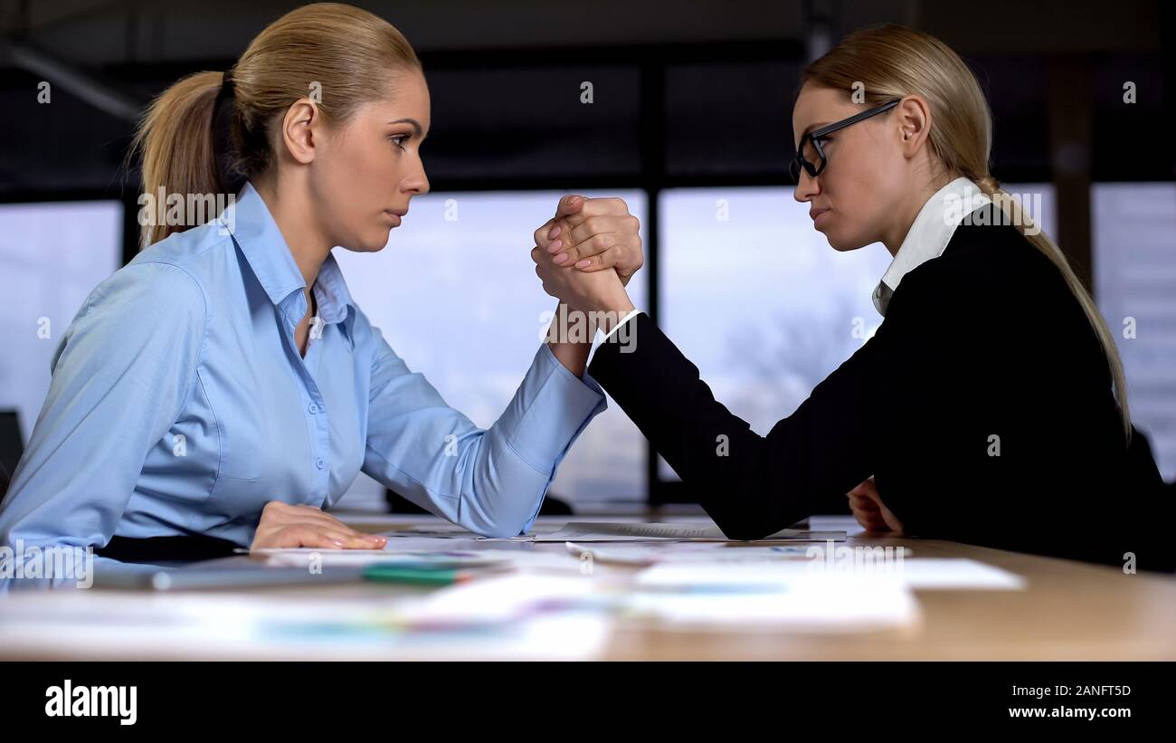 Two businesswomen doing arm wrestling in office, concept of rivalry at work Stock Photo Alamy