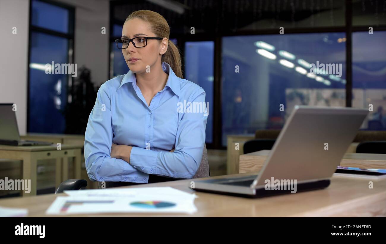 Businesswoman dissatisfied with data on laptop, low company income, bad news Stock Photo