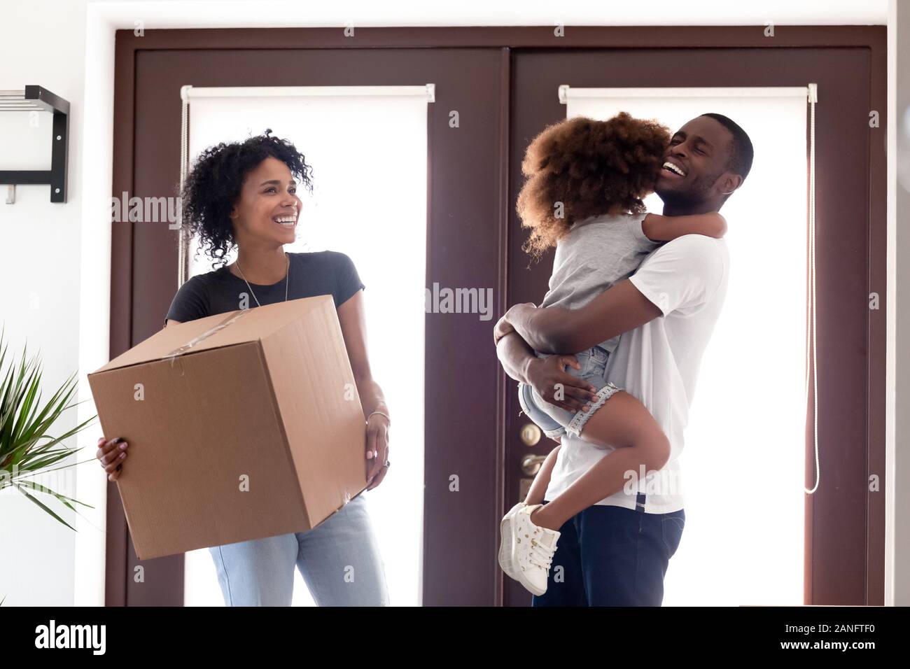 Excited African American family moving to new house Stock Photo - Alamy