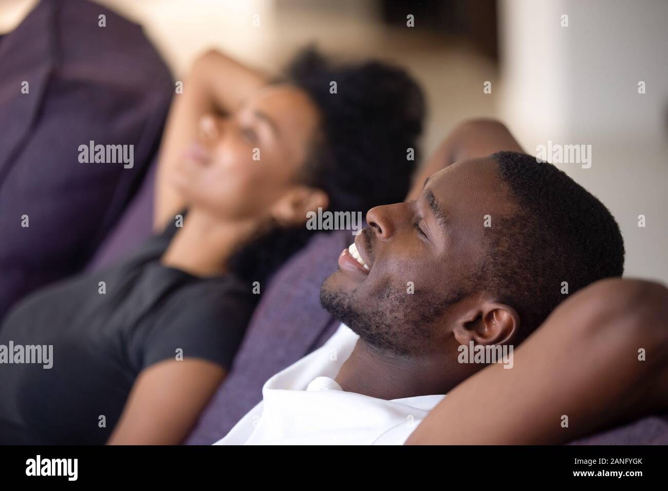 Close up of black couple relax on couch dreaming Stock Photo - Alamy