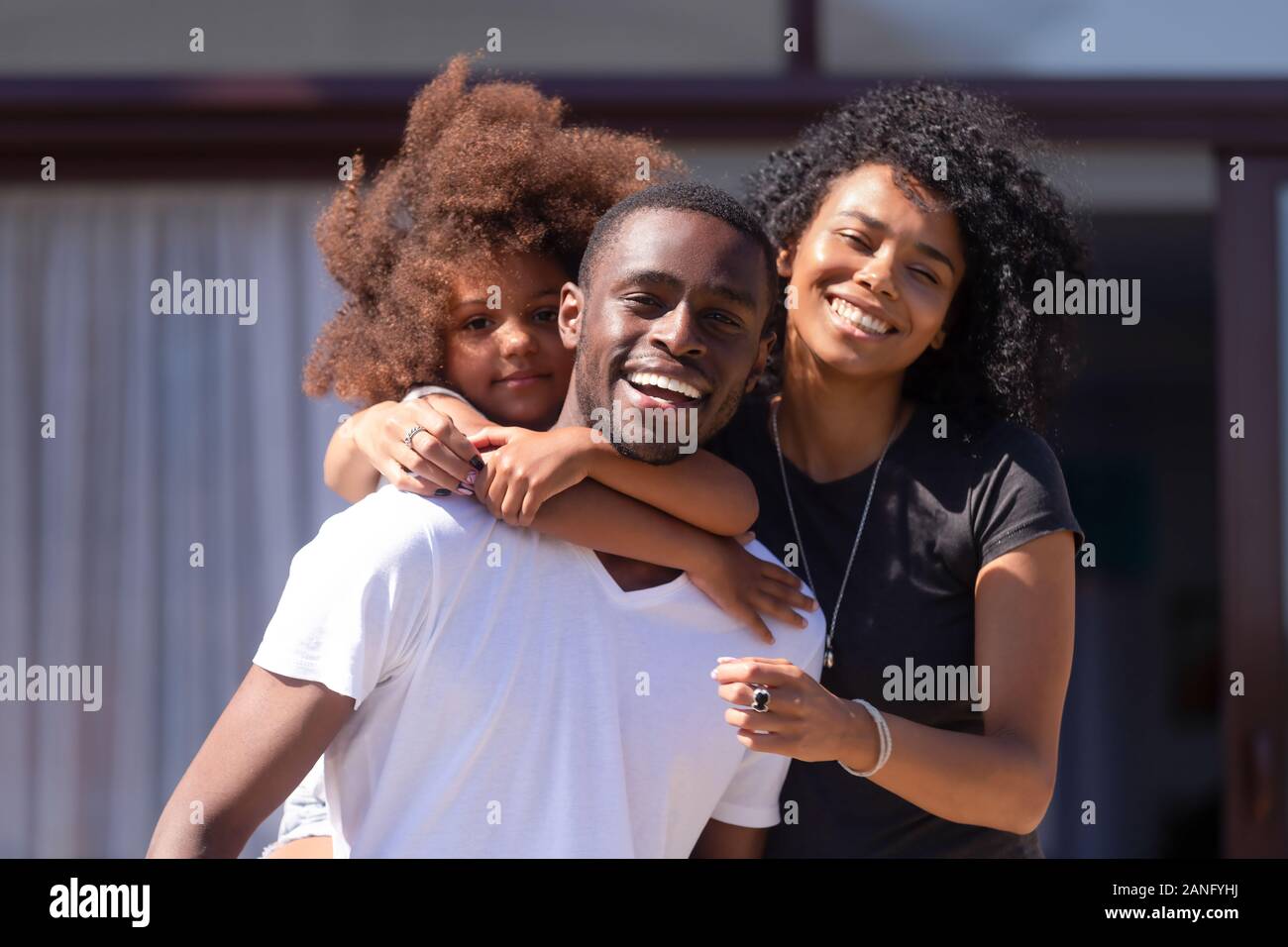 Portrait of happy African American family posing outside Stock Photo ...
