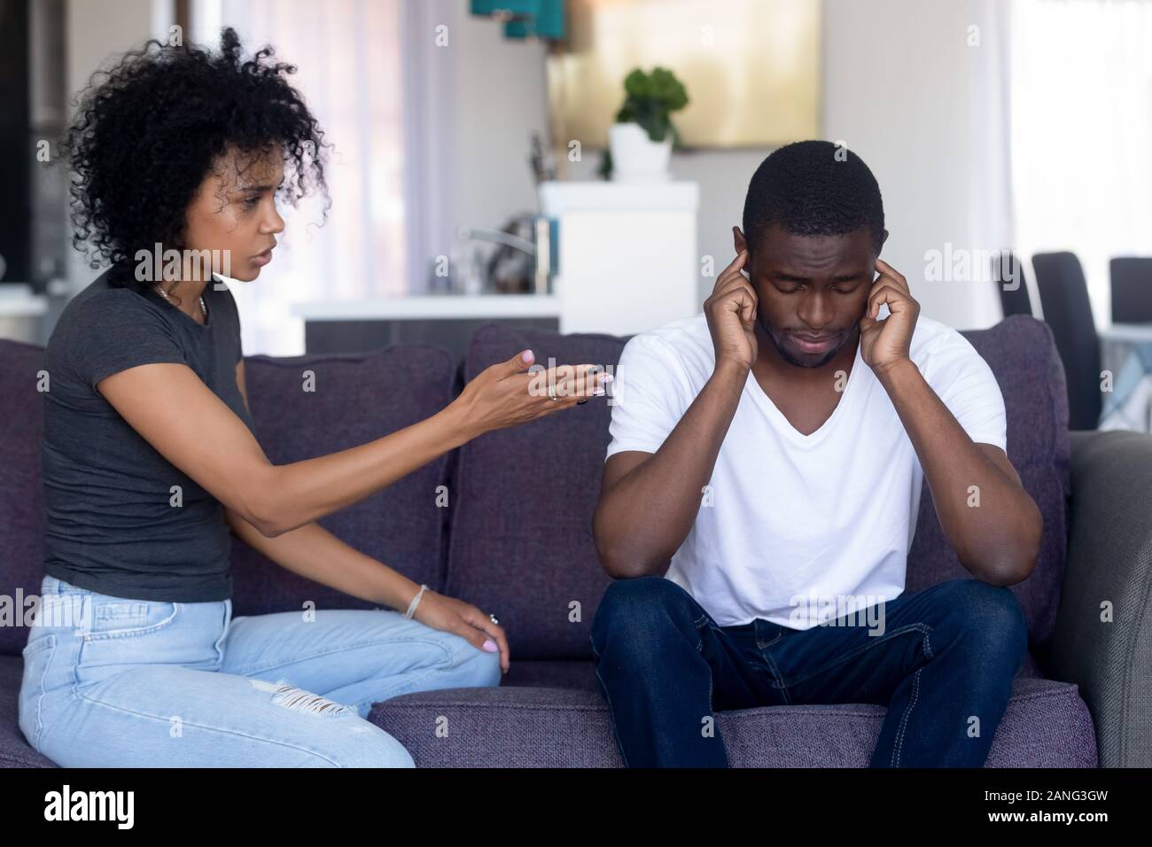 Indifferent black husband ignore pushy wife lecturing Stock Photo