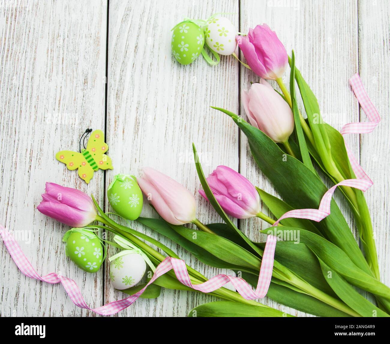 Easter eggs and tulips on a old wooden background Stock Photo - Alamy
