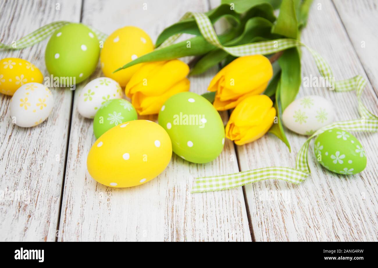 Easter eggs and tulips on a old wooden background Stock Photo - Alamy