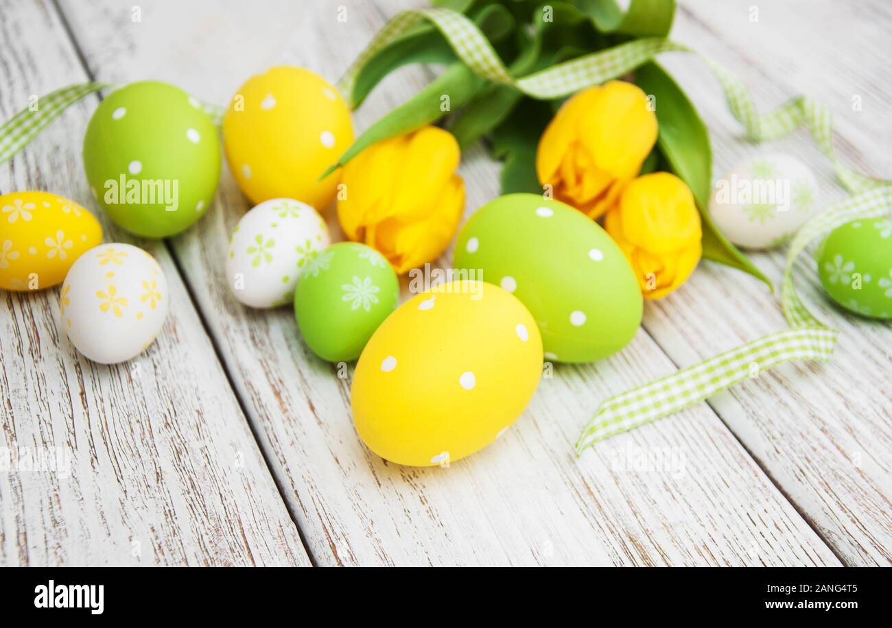 Easter eggs and tulips on a old wooden background Stock Photo - Alamy
