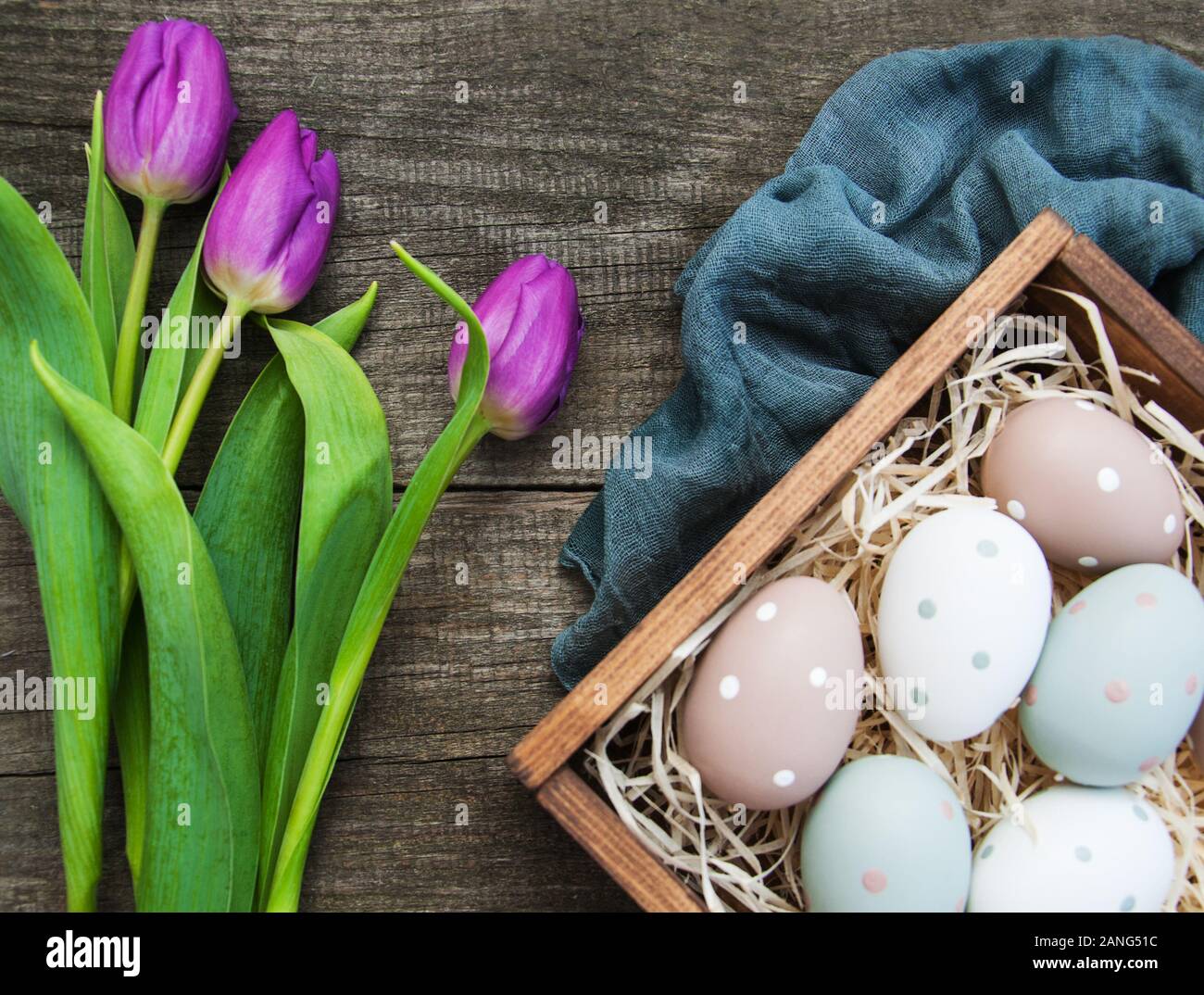 Easter eggs and tulips on a old wooden background Stock Photo - Alamy