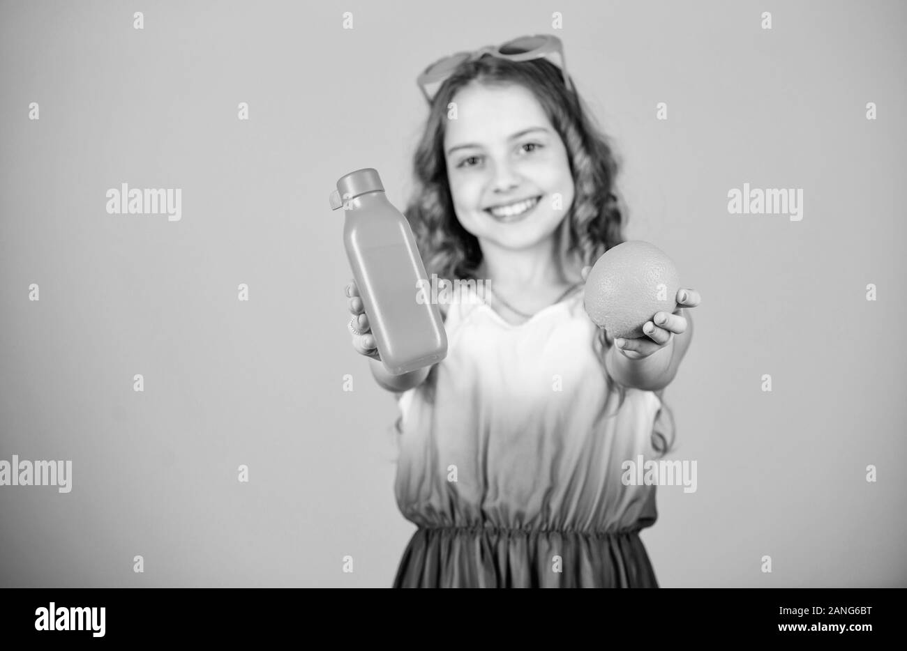 happy girl drink fresh orange juice. summer vacation. little girl in