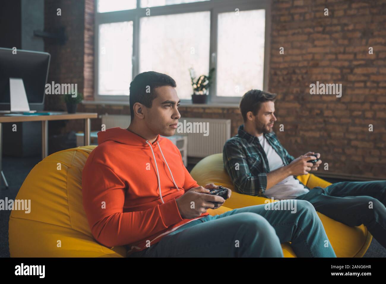 Serious young man holding a game console Stock Photo - Alamy
