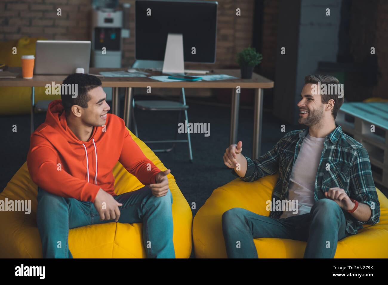 Joyful nice men enjoying their pleasant conversation Stock Photo