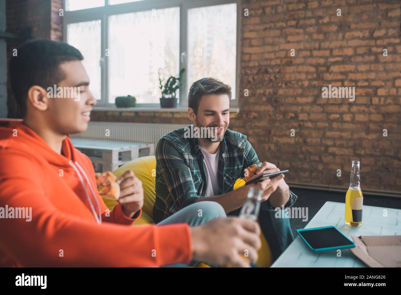 Positive nice friends having fun time at home Stock Photo