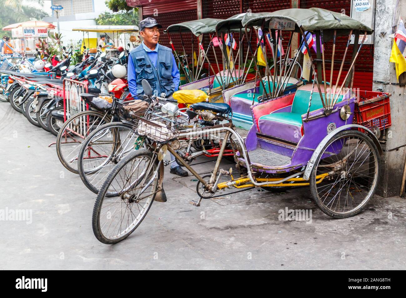 Nan, Thailand - December 16th 2014: Rickshaw drivers waiting for business, This form of transport is still used in remote areas, Stock Photo