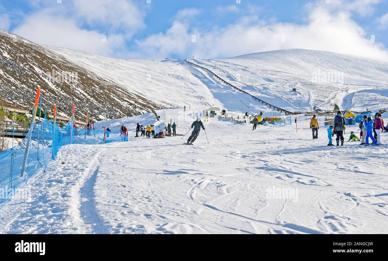 Men, women and children on sunny snow slopes at Cairngorm Mountain Ski Centre  Cairngorms National Park, Aviemore, Scottish Highlands, Scotland UK Stock Photo