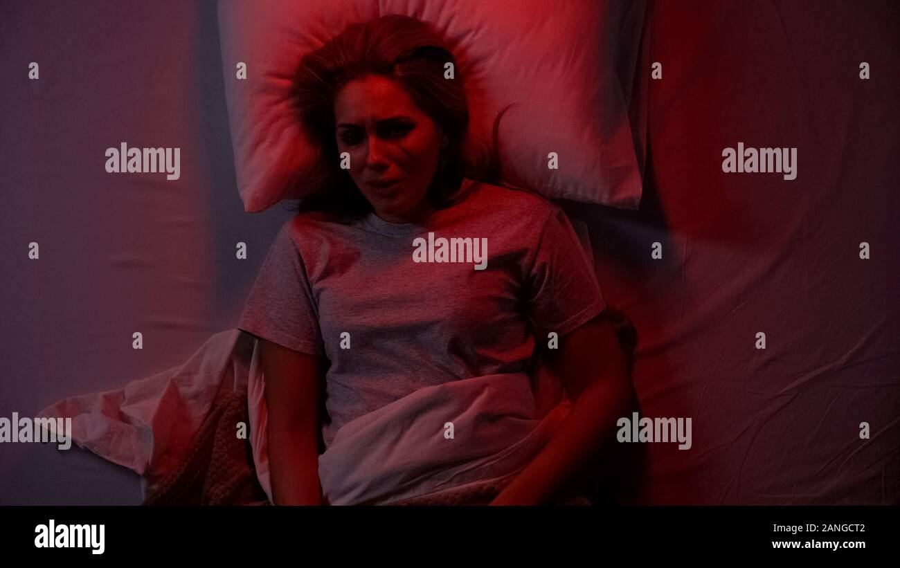 Woman alone bed night fear hi-res stock photography and images - Alamy