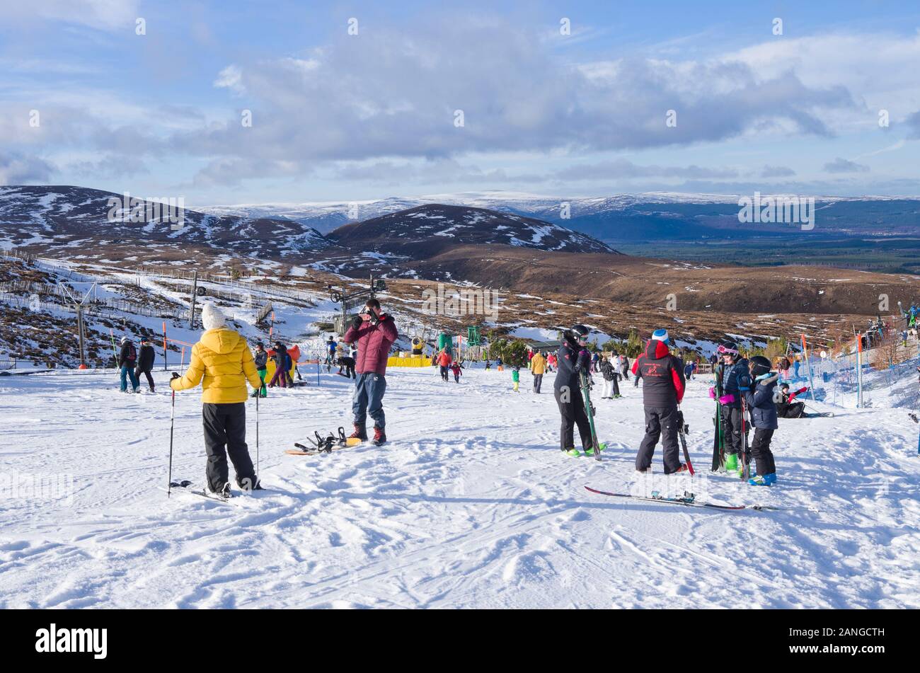 Men, women and children on sunny snow slopes at Cairngorm Mountain Ski Centre  Cairngorms National Park, Aviemore, Scottish Highlands, Scotland UK Stock Photo