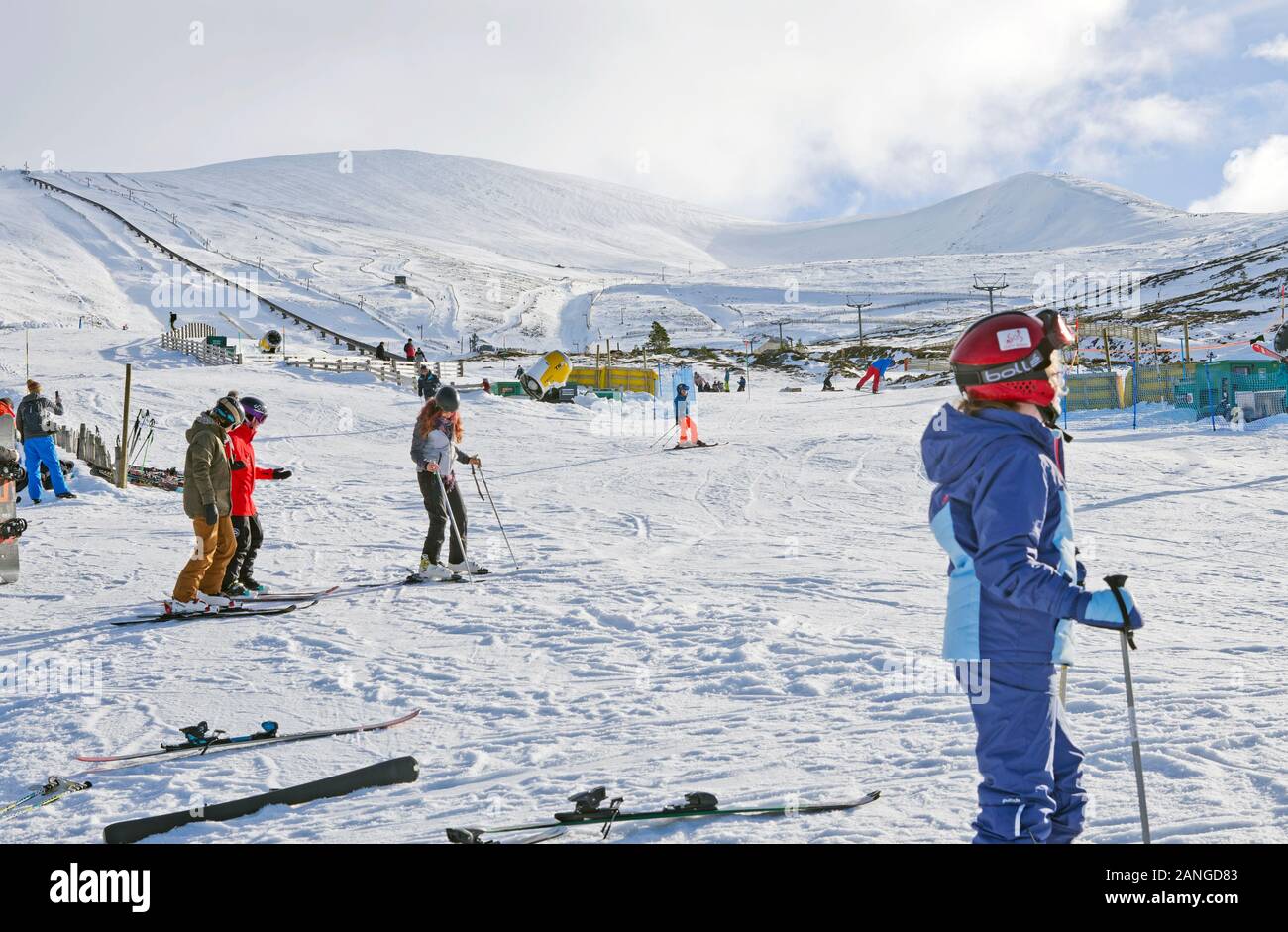 Skiers and snowboarders on sunny snow slopes at Cairngorm Mountain Ski Centre  Cairngorms National Park, Aviemore, Scottish Highlands, Scotland UK Stock Photo