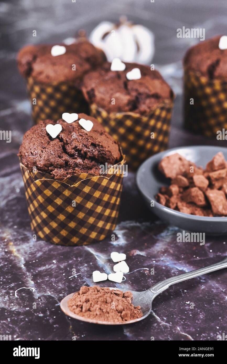 Homemade Chocolate Muffins With Heart Shaped Sugar Sprinkles In Paper Case With Cup And Spoon With Cocoa Powder On Dark Marbel Background Stock Photo Alamy