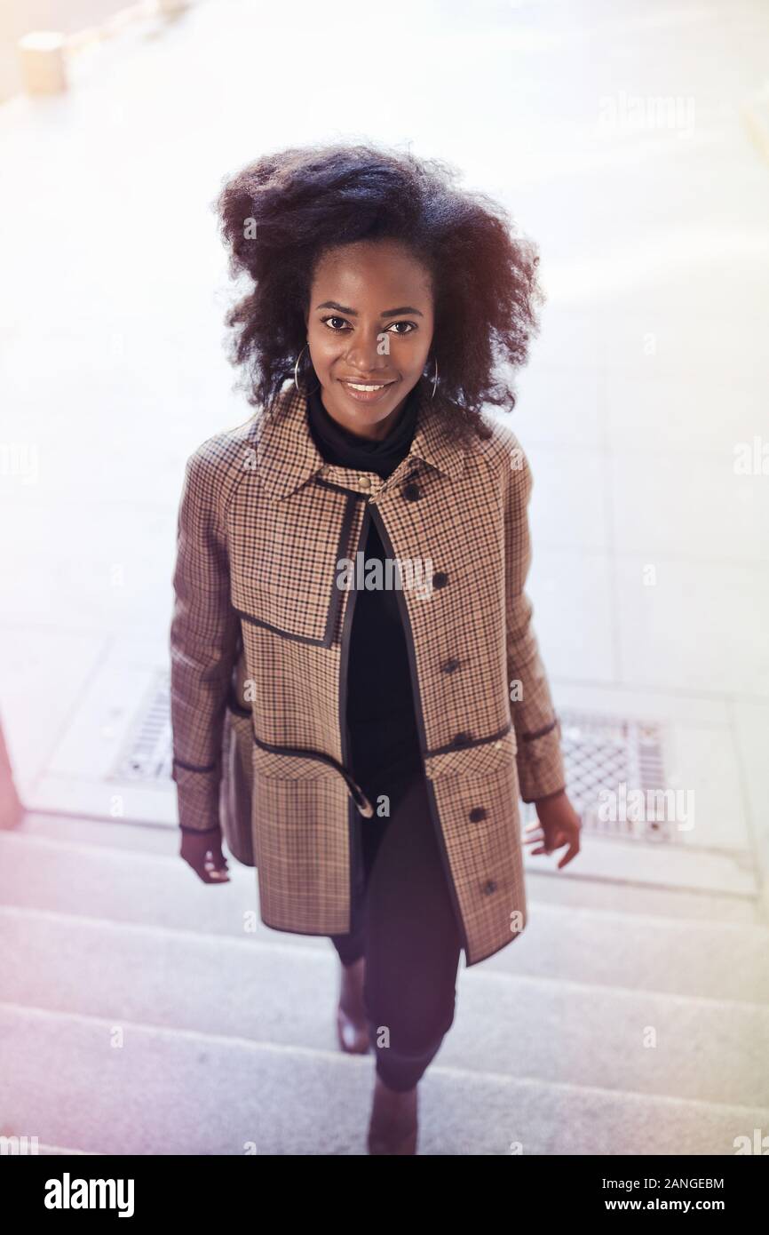 Beautiful african american young woman with afro and large hoop ...