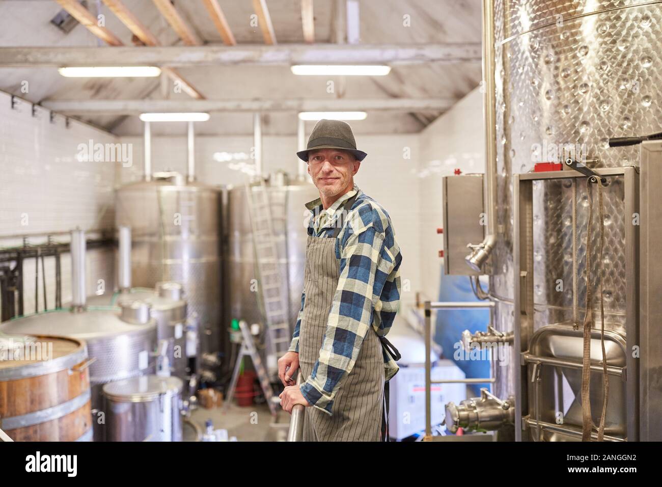 Man as a winemaker or master brewer in the winery or brewery Stock Photo
