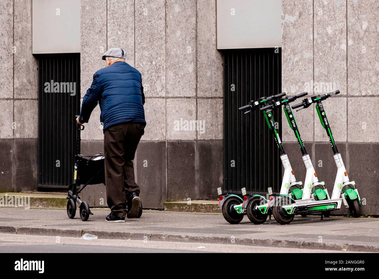 Pensioner with Rollator passes Lime's e-scooter in downtown Cologne. Koln, January 16, 2020 | usage worldwide Stock Photo
