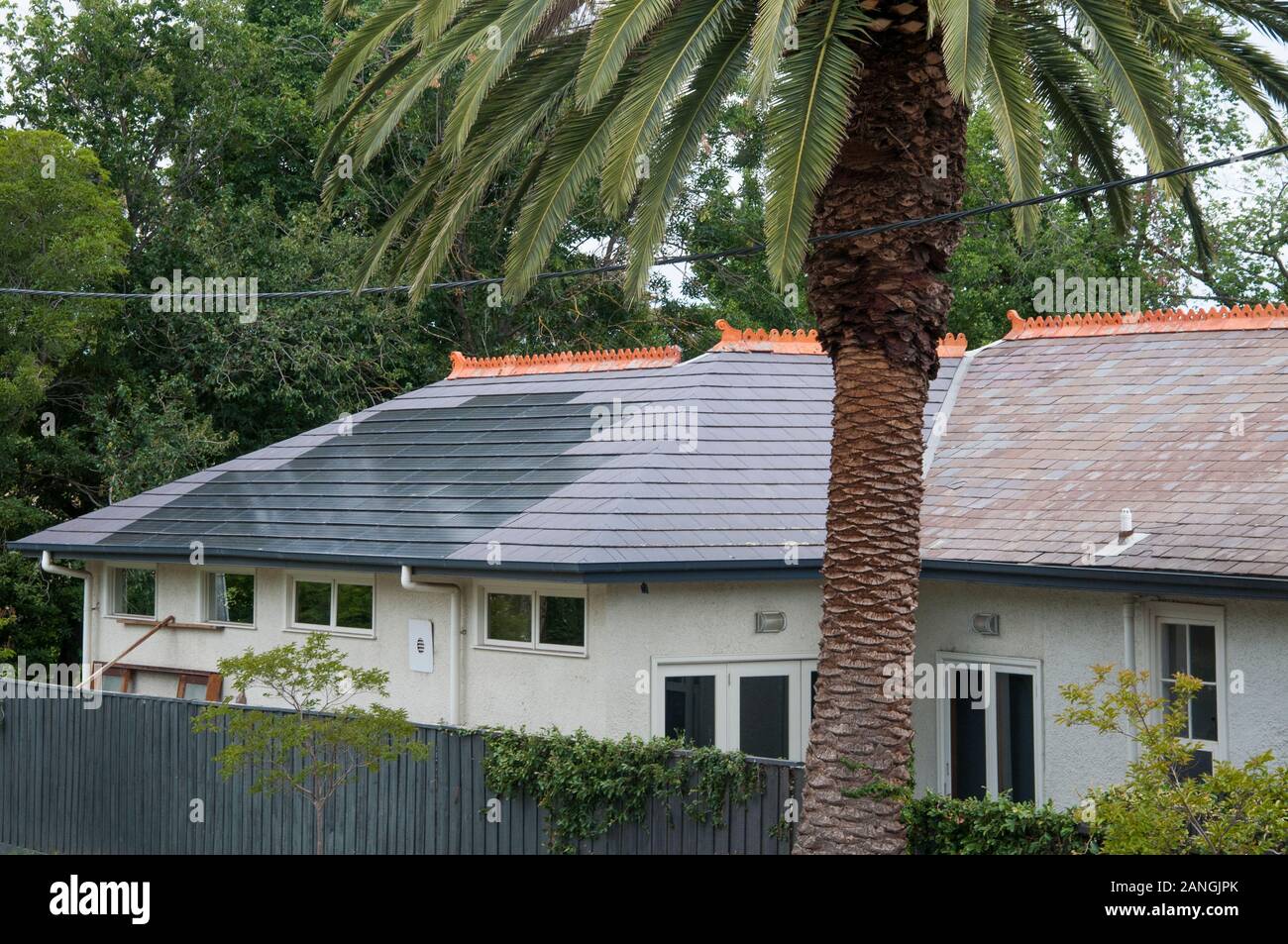 Solar photovoltaic collector cells blend with roof tiles (slates) in Melbourne, Australia Stock Photo