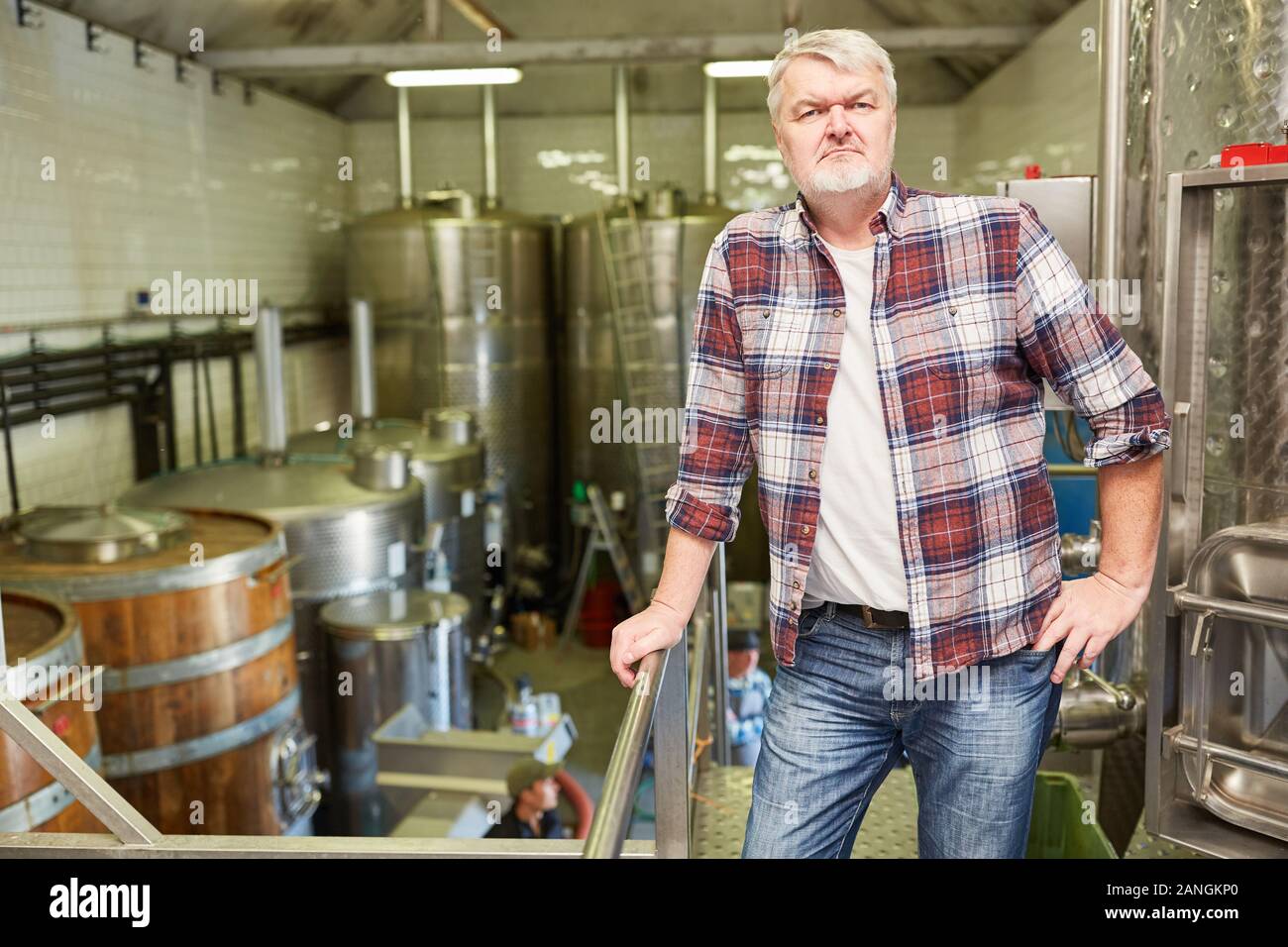 Man as a brewer or winemaker with experience in the winery or brewery Stock Photo