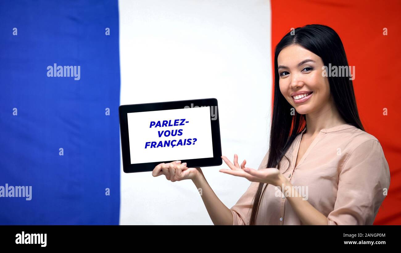Woman holding tablet with do you speak french phrase, app for learning