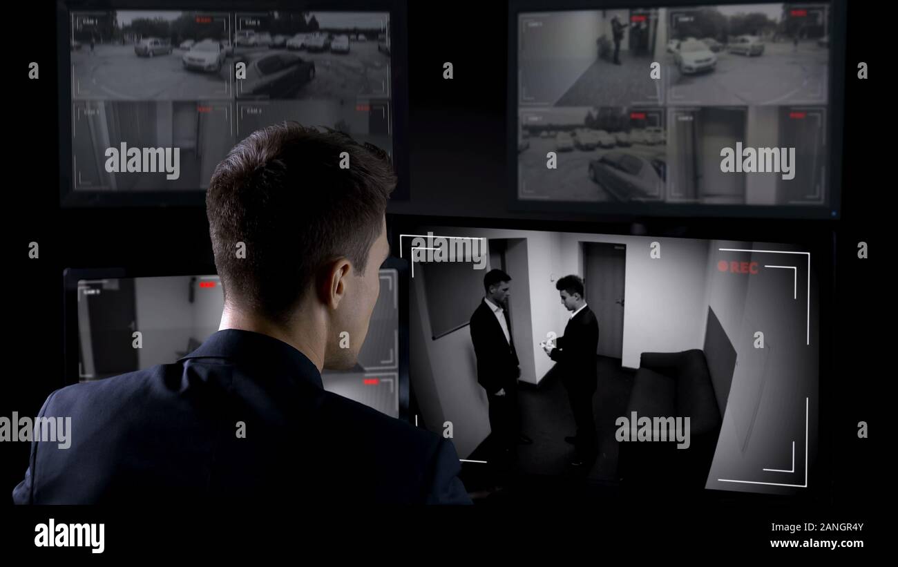 Security man looking at monitors hi-res stock photography and images ...