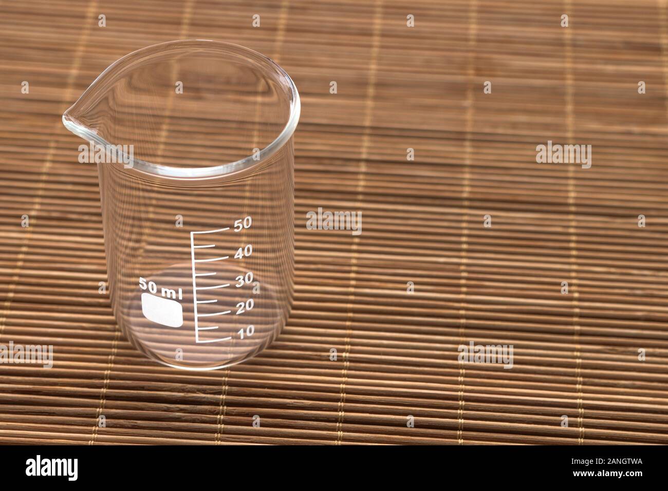 https://c8.alamy.com/comp/2ANGTWA/an-empty-glass-50-ml-beaker-on-a-wooden-surface-2ANGTWA.jpg